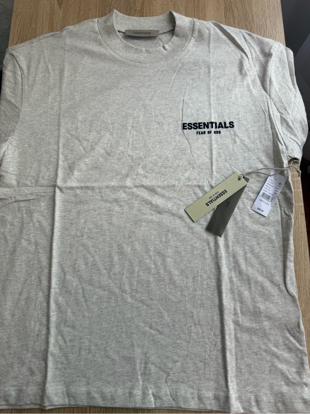 Fear of God Essentials Men’s Cream T-Shirt with Black Chest Logo